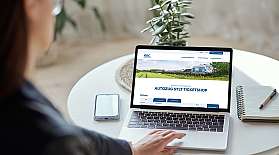 Eine Frau schaut auf den Screen eines Laptops, auf dem der Online-Shop vom blauen AUTOZUG Sylt geöffnet ist.